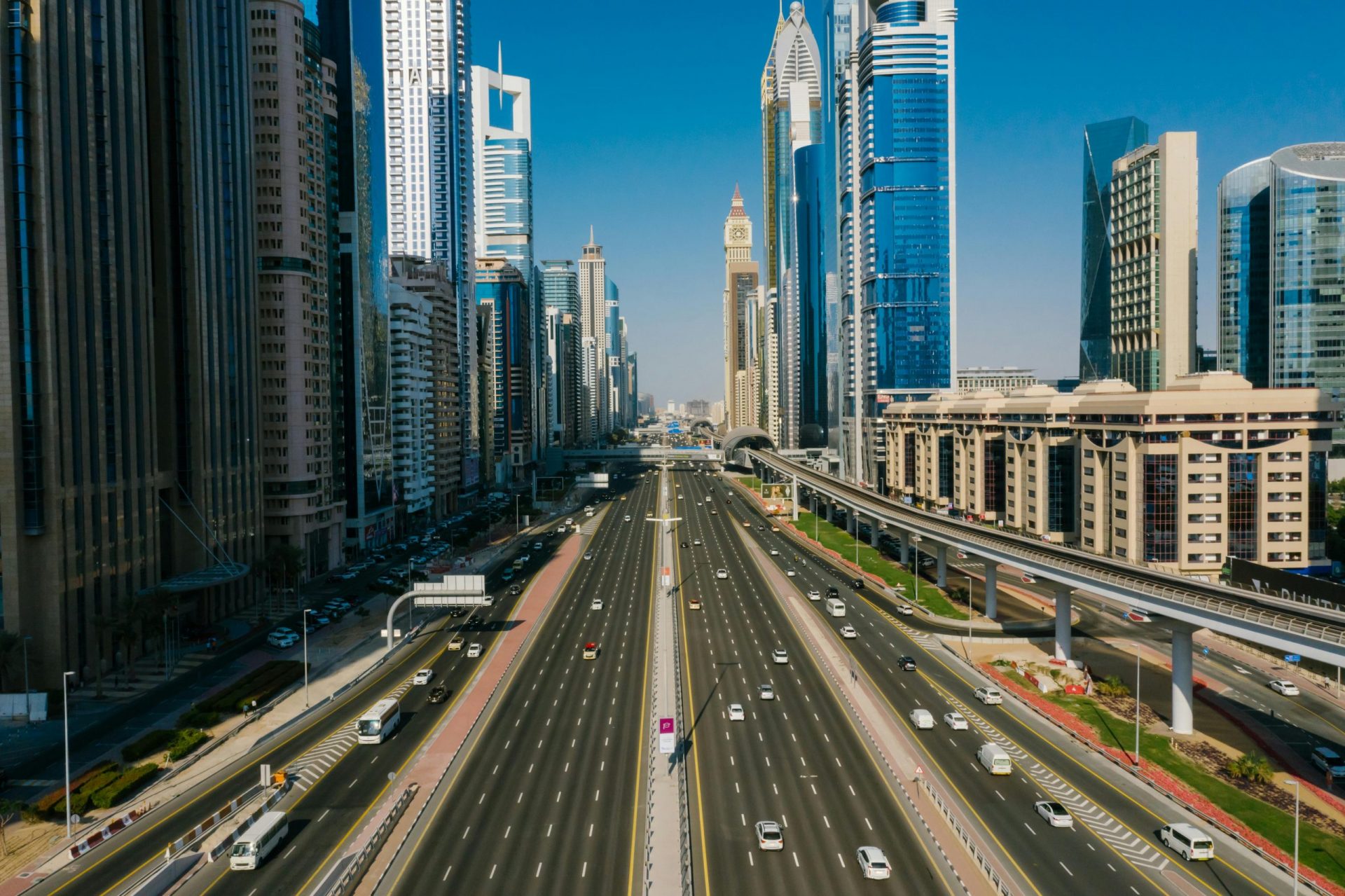 vehicles crossing Dubai on the road surrounded by skyscrapers